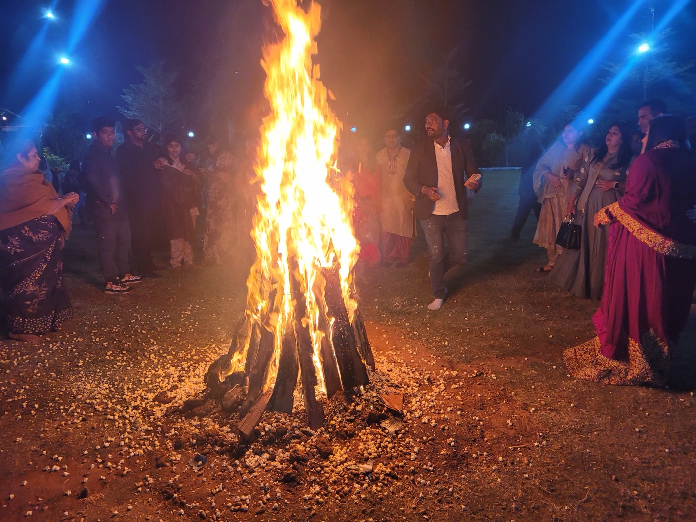 Guests around a bonfire on the lawn on a winter evening