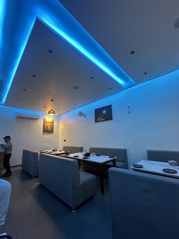 The AC hall at Greenway Restaurant: booth seating under blue cove lights